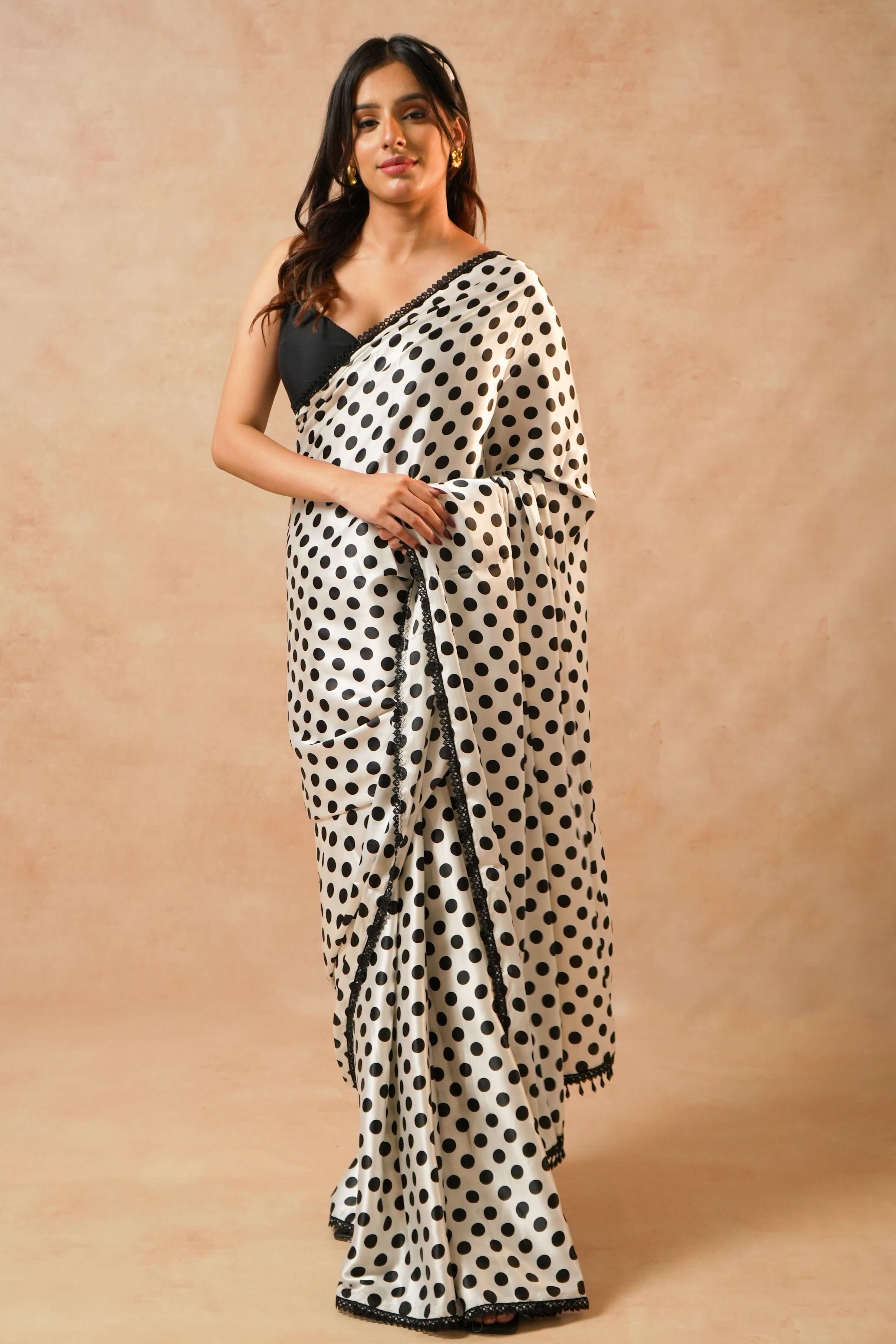 Naomi Designer Polka Dot Satin Saree with Crystal Lace worn by a model against a textured background.