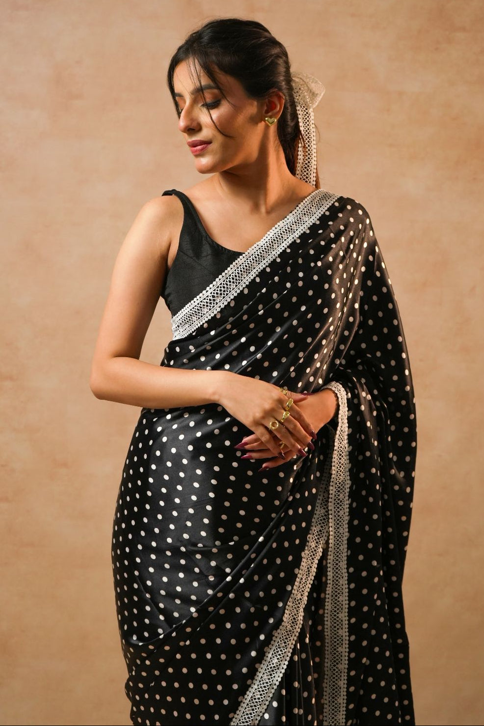 Daisy Dot Black Satin Polka Dot Saree with Crochet Border worn elegantly by a model.