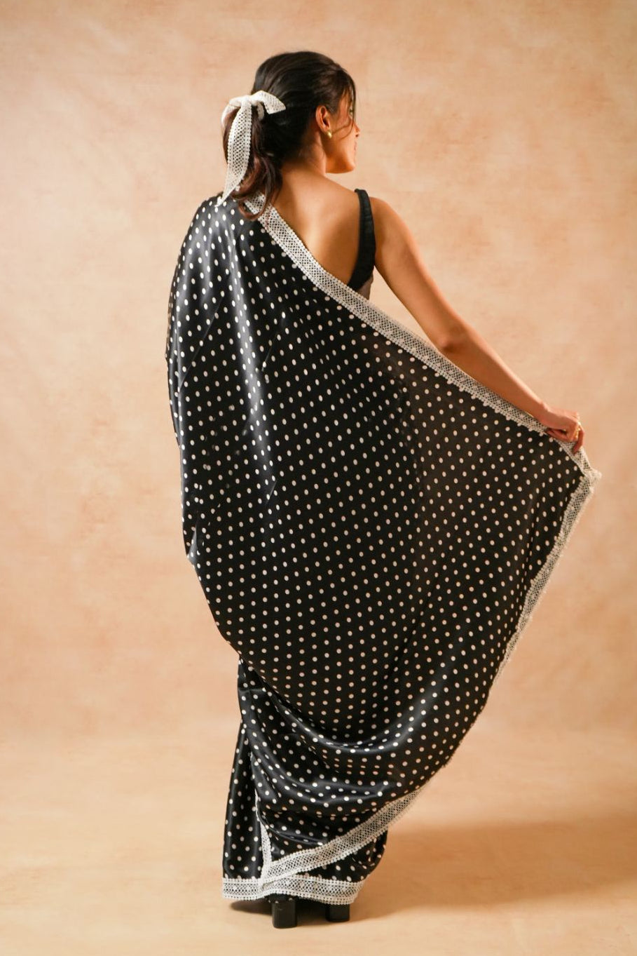 Daisy Dot Black Satin Polka Dot Saree with Crochet Border worn elegantly from the back.