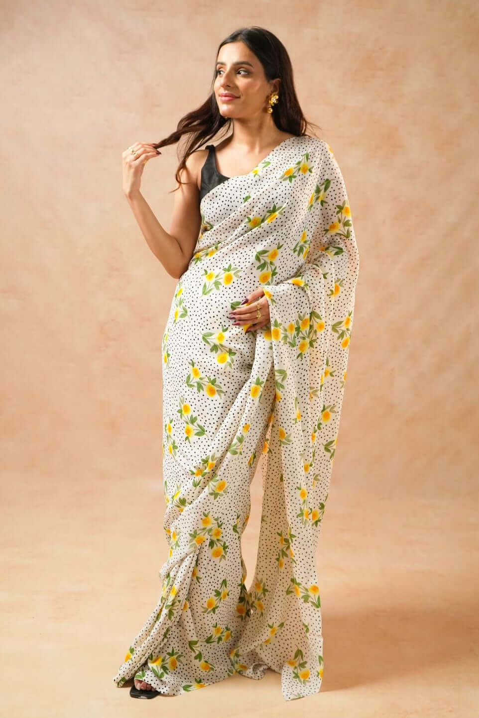 Flora Dot White Pure Georgette Saree with Floral Print worn by a model posing elegantly.