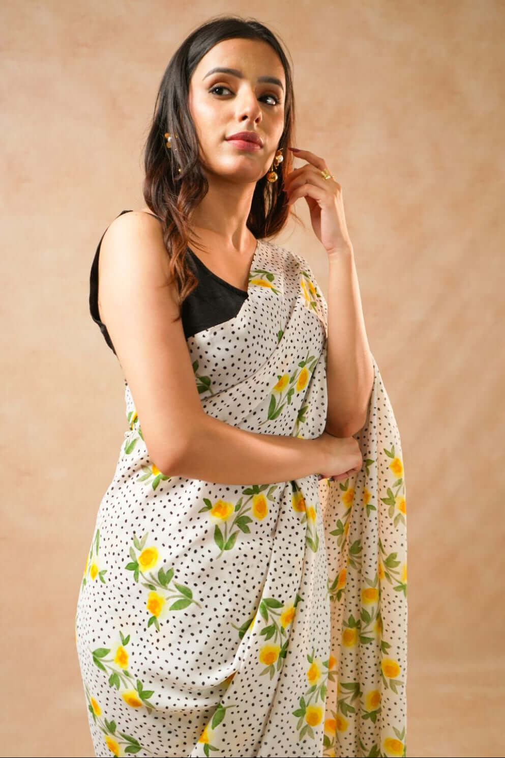 Flora Dot White Pure Georgette Saree with Floral Print worn by a model posing elegantly.