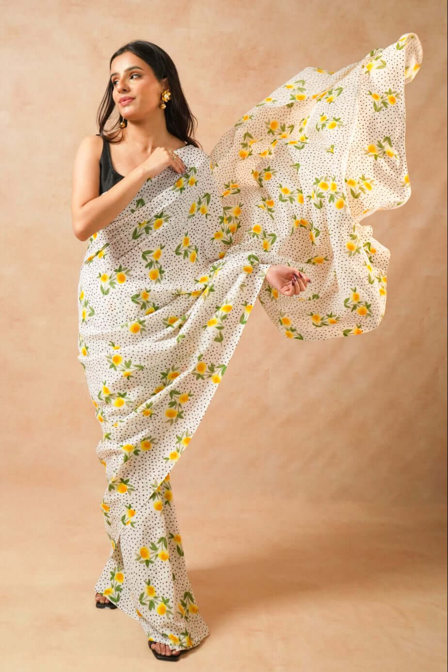 Flora Dot White Pure Georgette Saree with Floral Print worn by a model posing elegantly.
