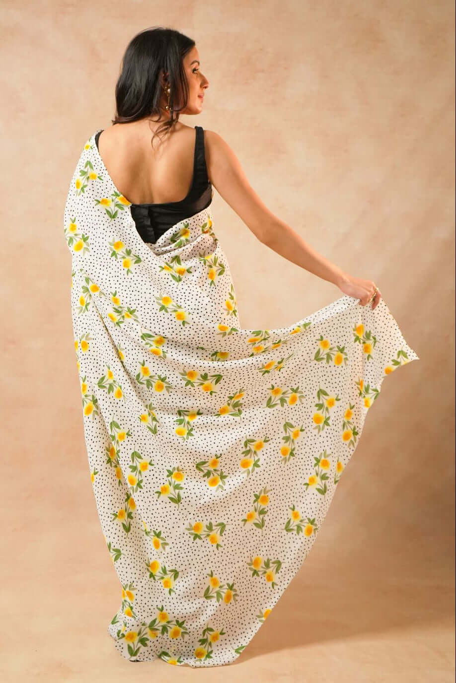 Flora Dot White Pure Georgette Saree with Floral Print worn by a model posing elegantly.