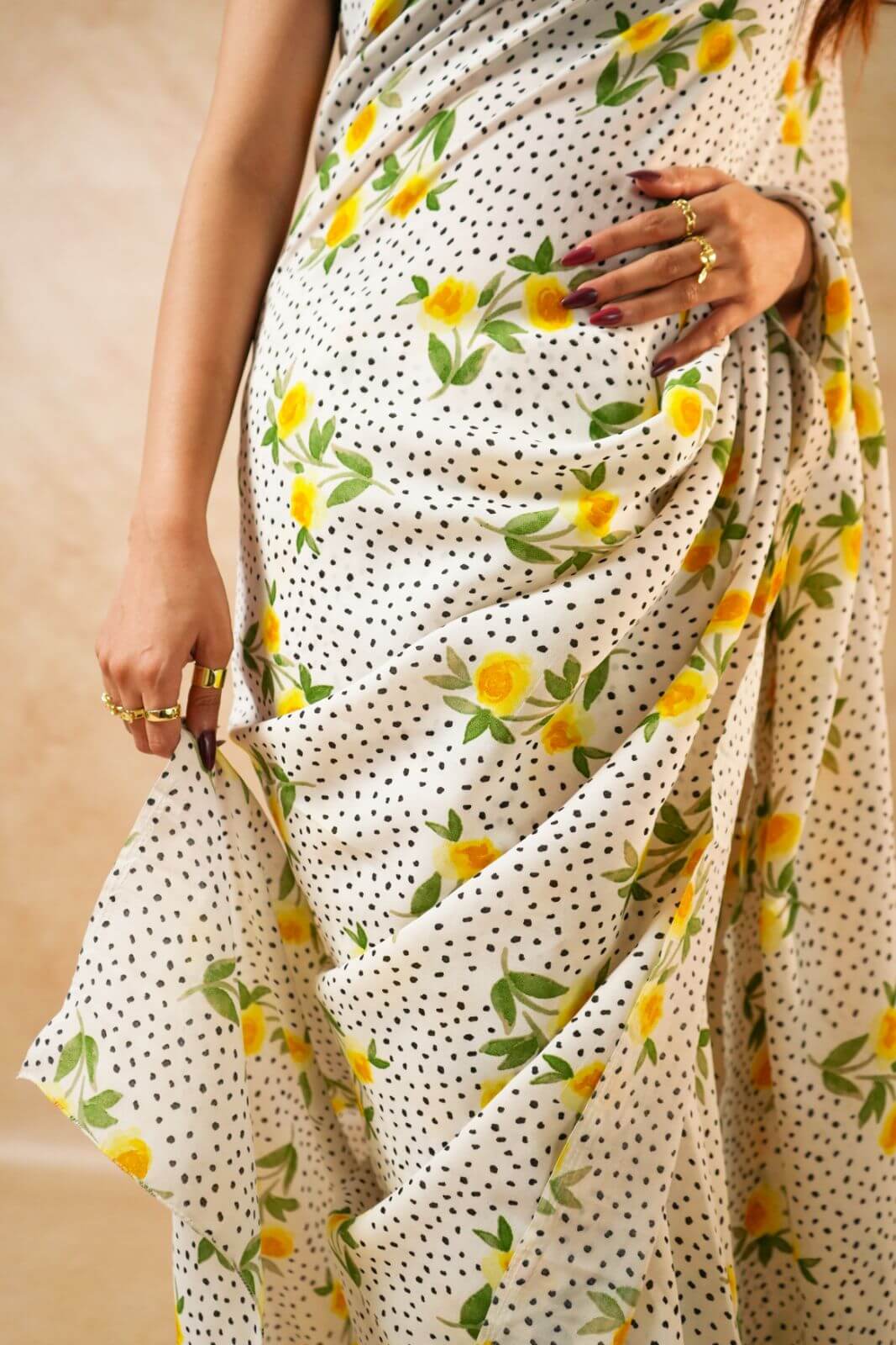 Flora Dot White Pure Georgette Saree with Floral Print worn by a model posing elegantly.
