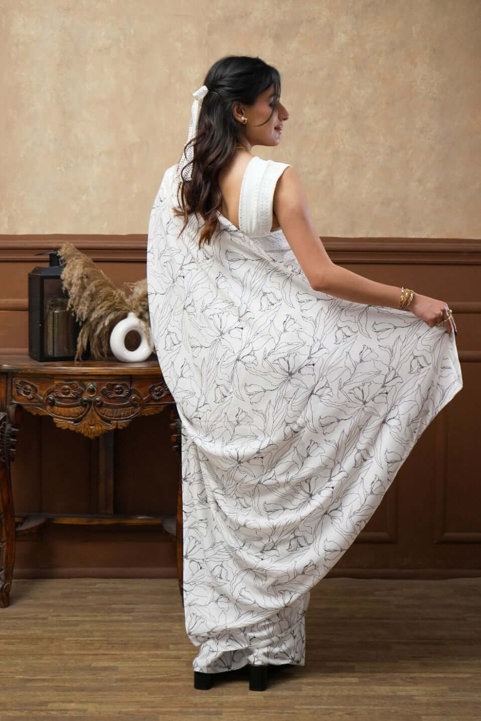 A woman models a White Tulip Digital Print Georgette Saree