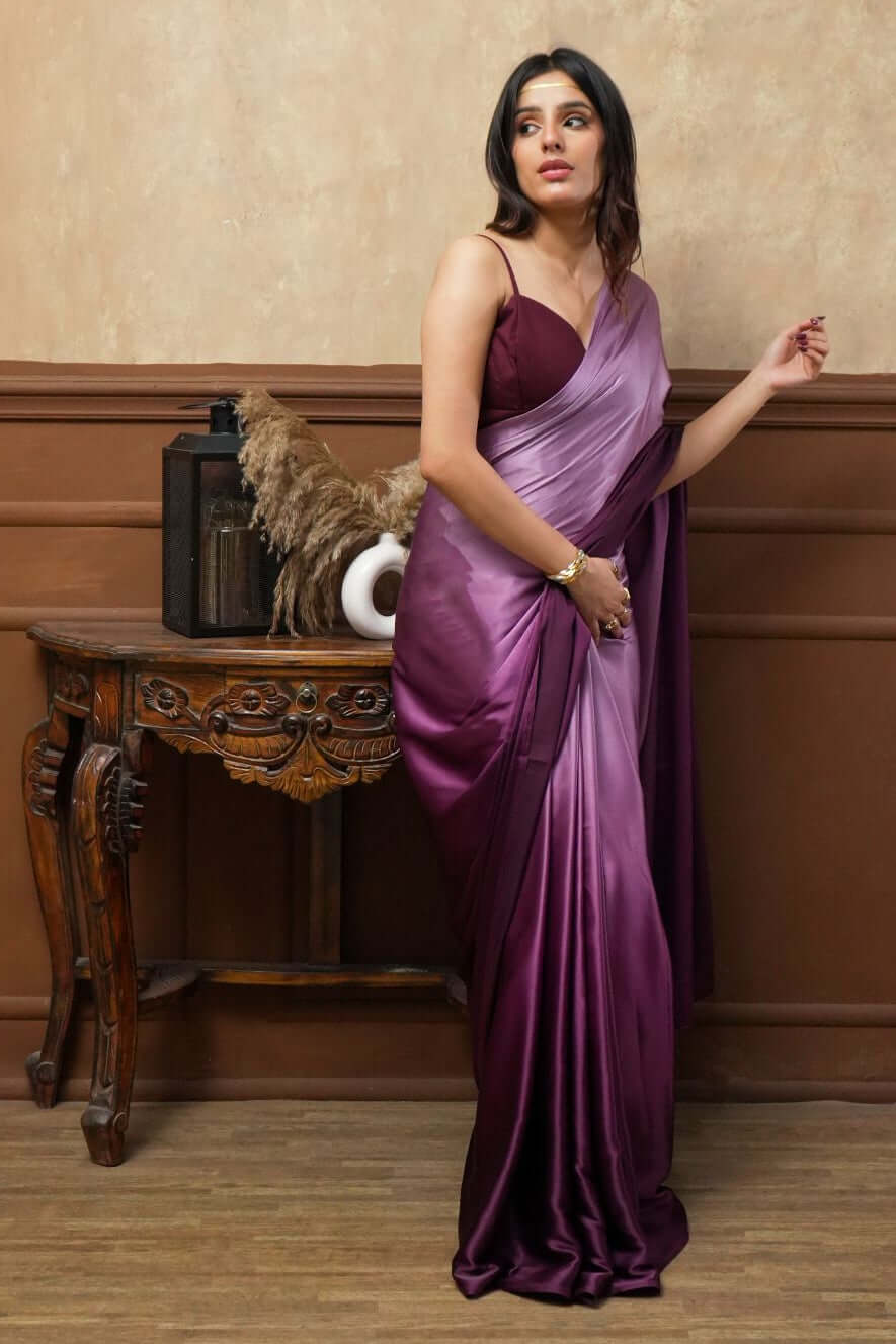 A woman models Viola Burgundy Glass Shine Satin Saree