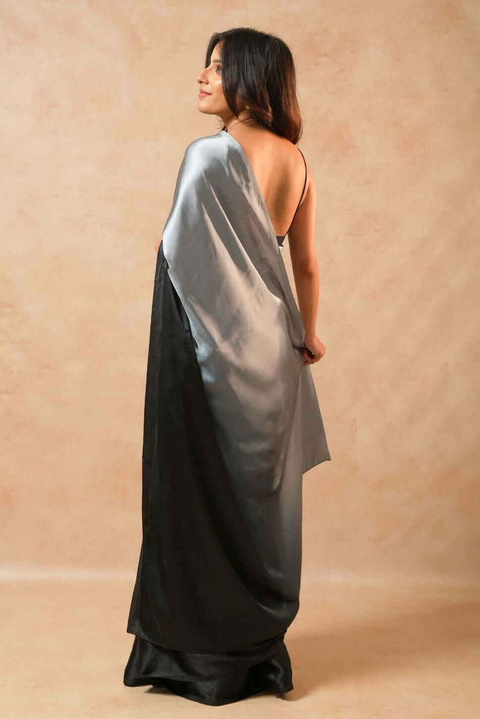 Shop the Moon Night Black Glass Shine Satin Saree in premium satin. 